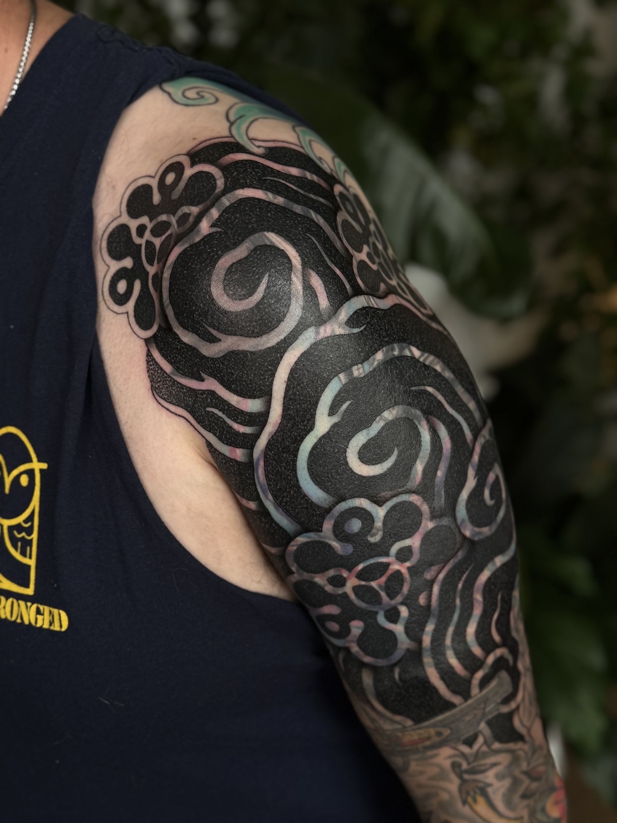 Japanese-inspired blackwork blast-over sleeve over an old colour tattoo, by Si, Bristol