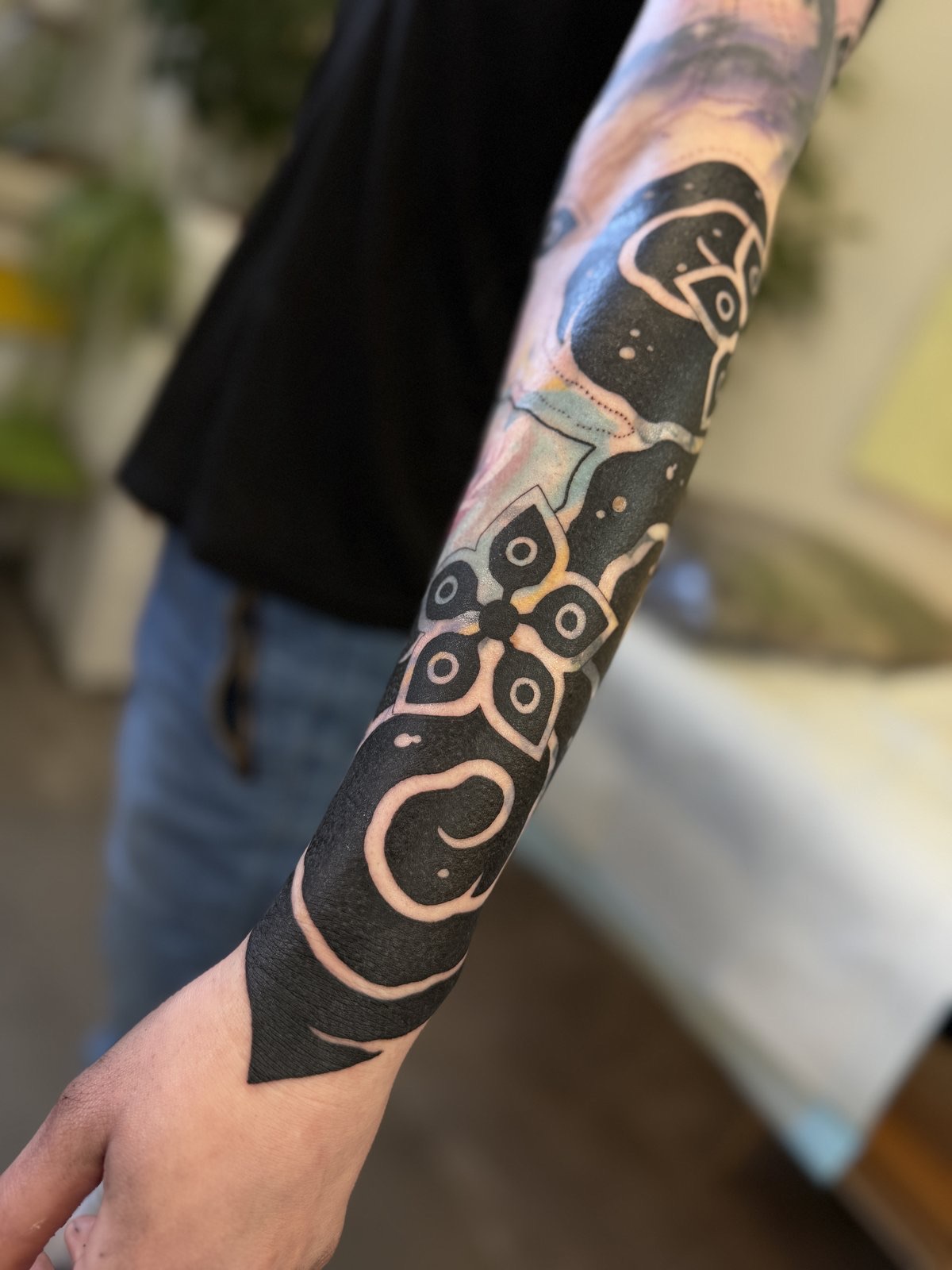 Blackwork blast-over over an old tattoo, by Si, Bristol