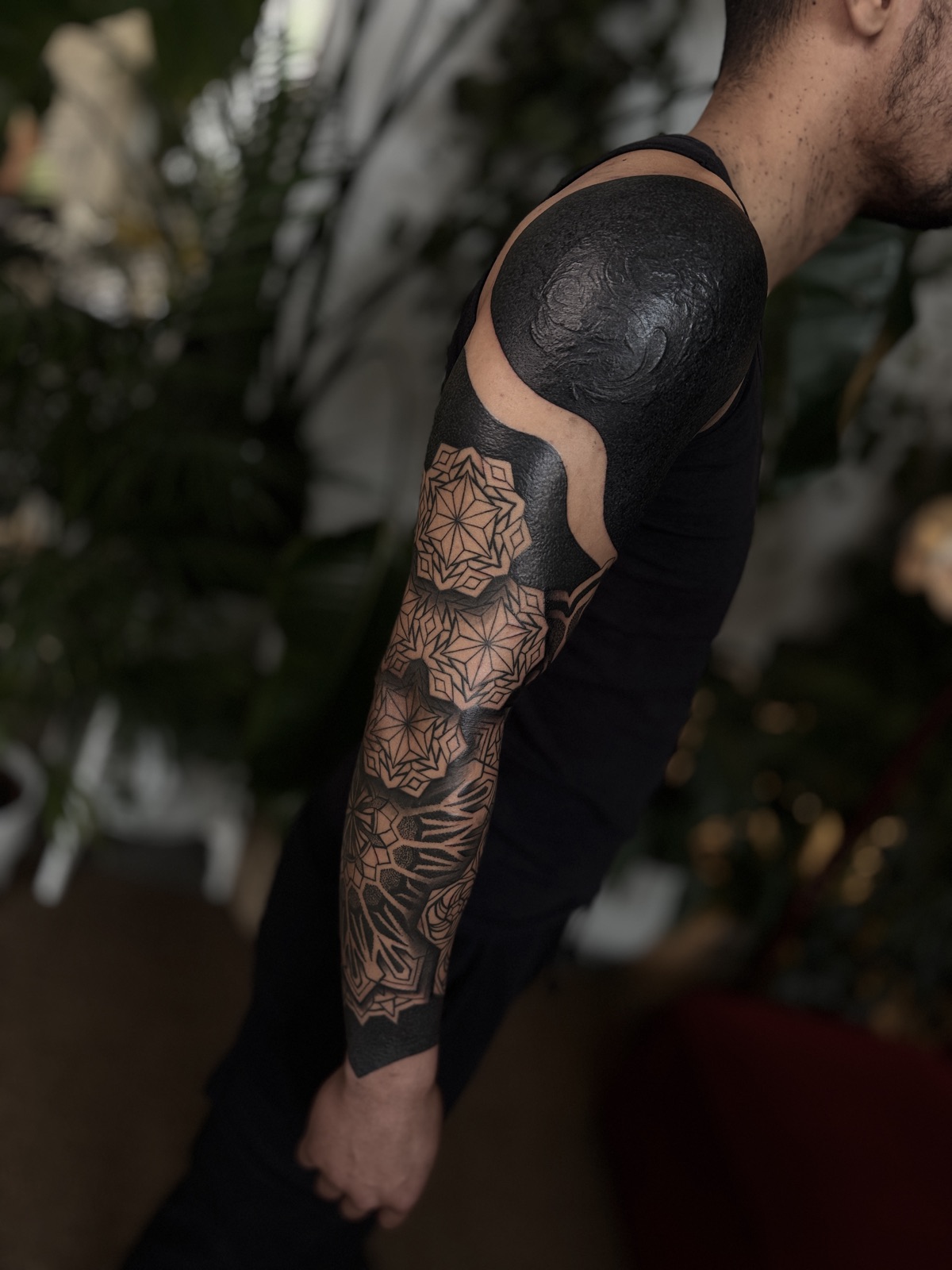 Custom geometric blackwork sleeve with blackout shoulder
