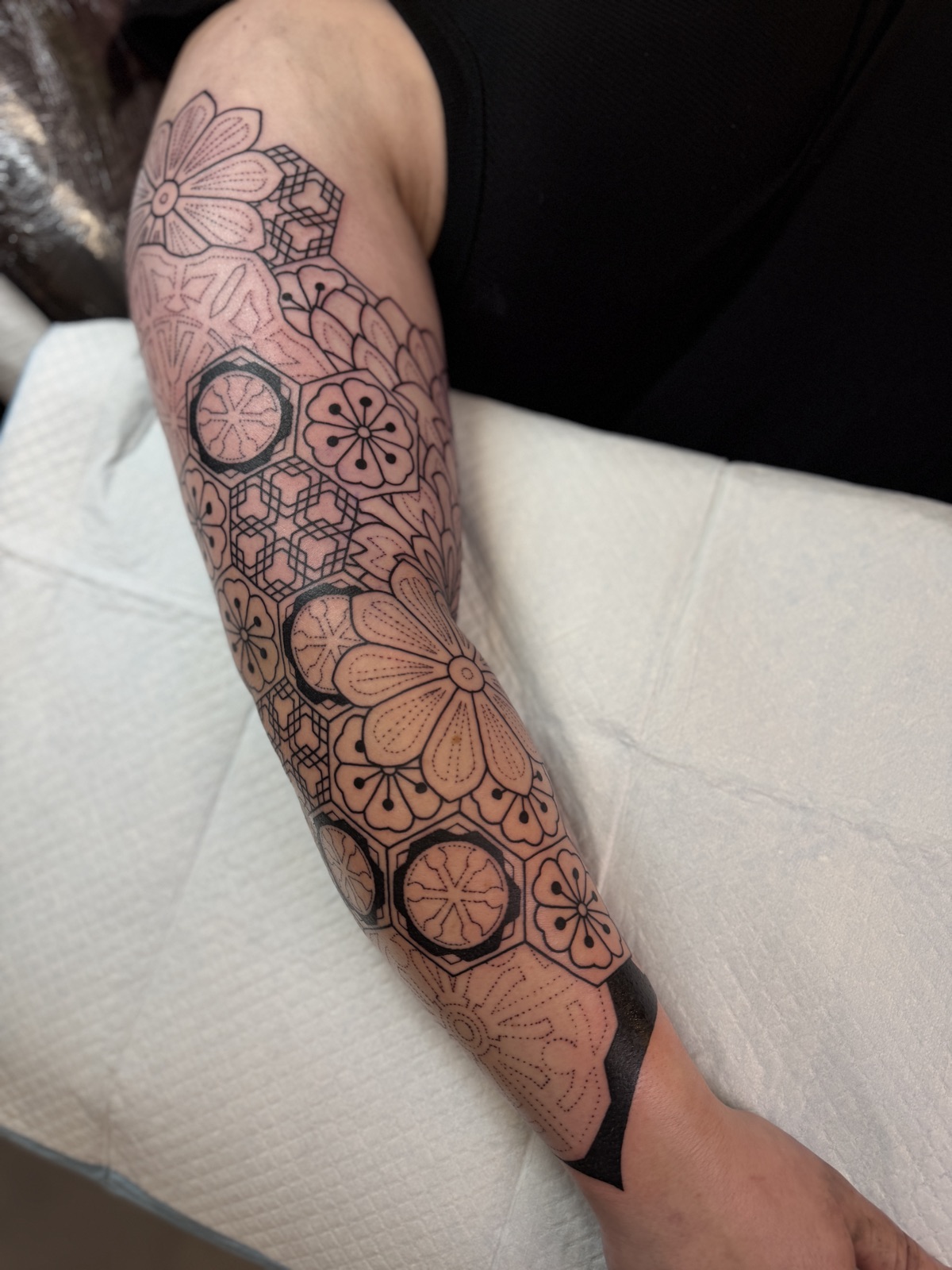Japanese-inspired geometric blackwork sleeve with kimono and cherry-blossom motifs, by Si, Bristol