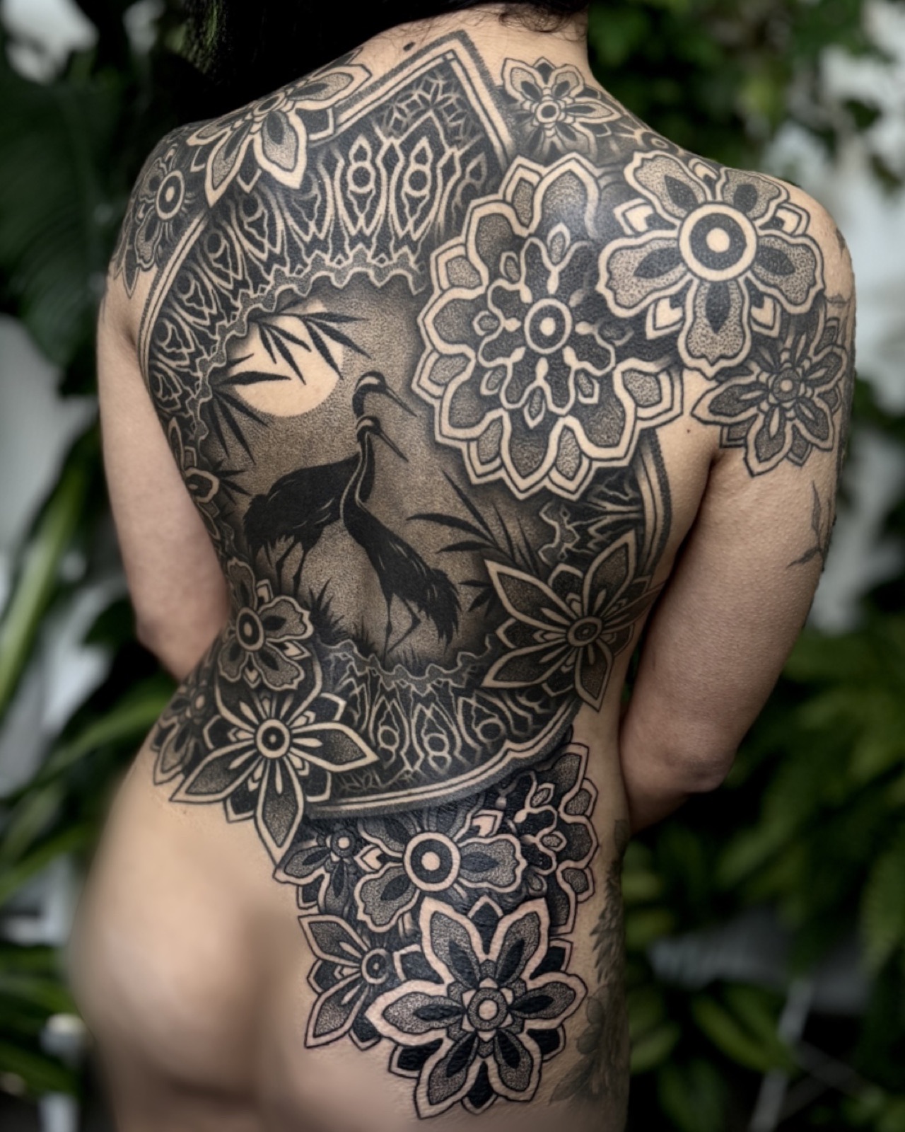 Full back blackwork piece with crane and mandalas