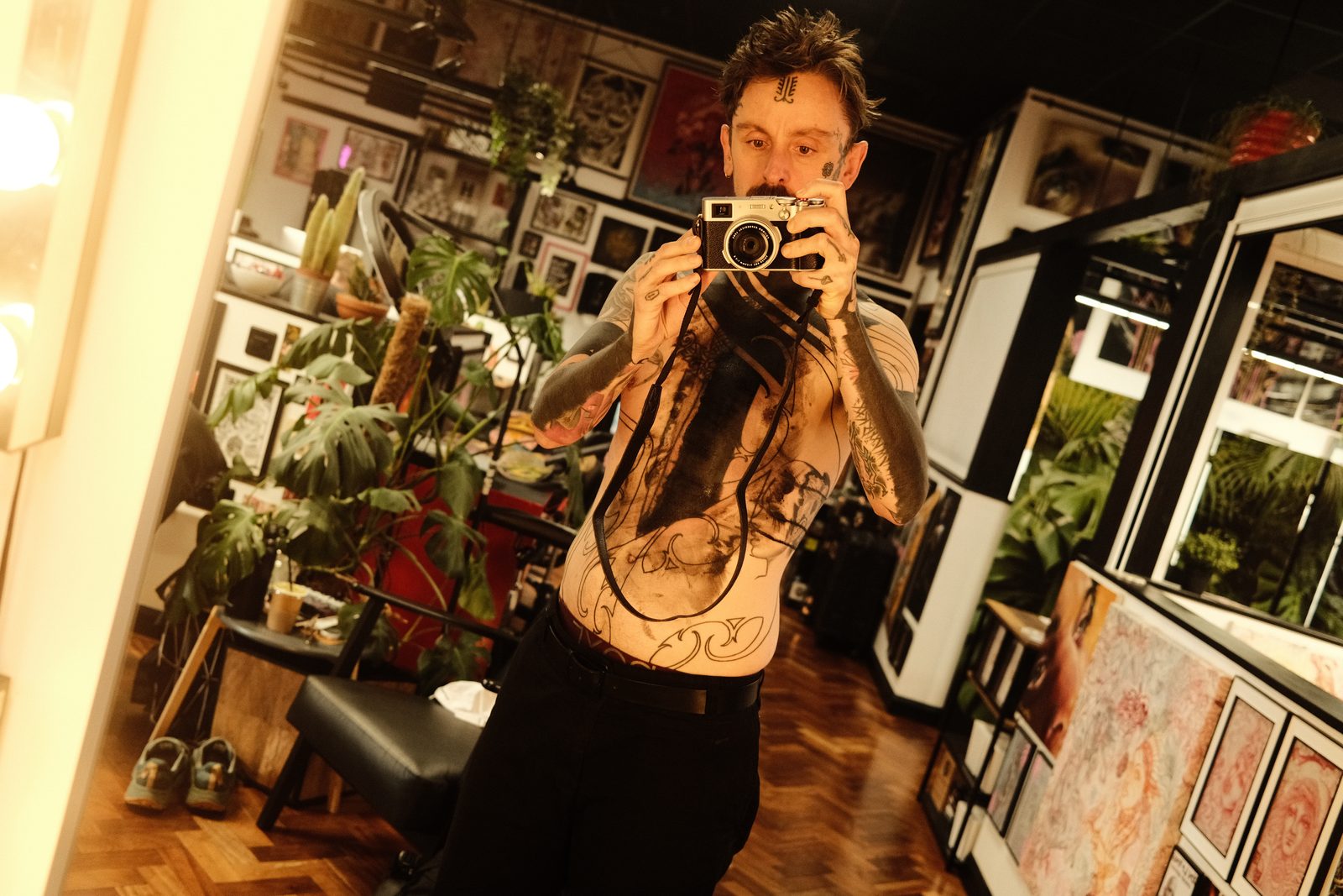 Tattoo artist Si getting his chest blacked out in a Bristol studio