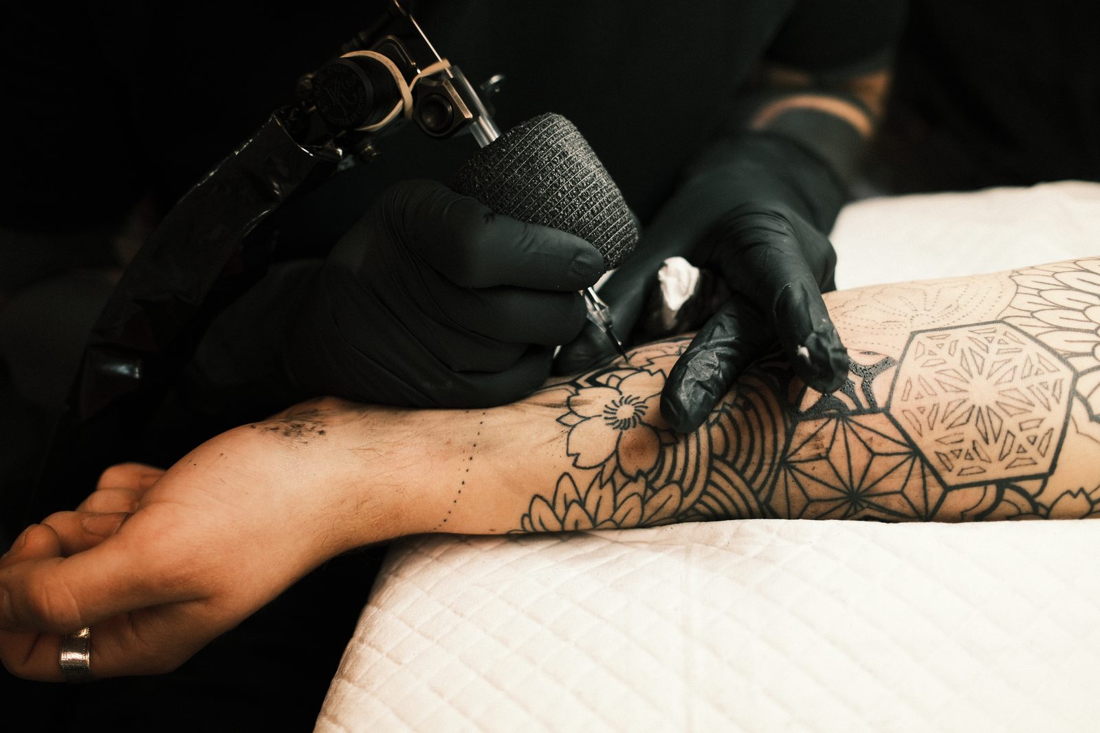 Close-up of a painful wrist tattoo being worked on